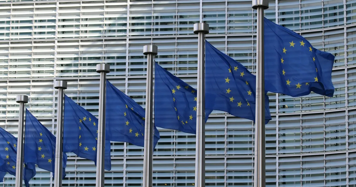 Row of EU flags outside the European Commission's Berlaymont building in Brussels